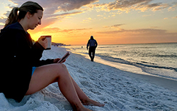 Woman having coffee on the beach after purchasing a Lavallette home for sale