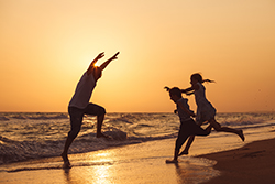 Family playing on beach after purchasing home in Seaside Park