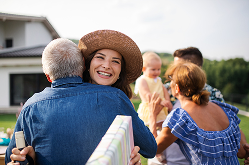 Family hugging and smiling outside Ortley Beach vacation rental
