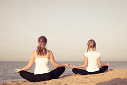 Family doing yoga on the beach in Seaside Park