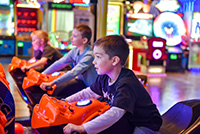 Kids on motorcycle game in arcade
