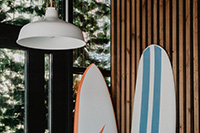 Surfboards leaning against a wood wall